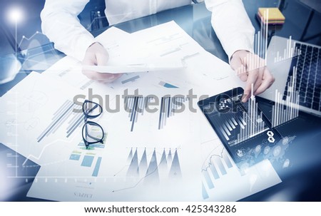 Sales Management Time Process.Photo trader work market report documents.Use electronic devices.Work graphics icons,stock exchanges reports interfaces.Business project startup.Horizontal,film effect.