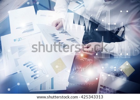 Risk management work process.Photo banker holding statistics document hands.Using electronic devices.Graphic icons,stock exchange reports screen interfaces.Business startup.Flares effect.