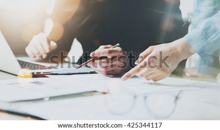 Photo Coworkers Team Working Modern Office.Man Using Generic Design Laptop Holding Pencil. Account Manager Work New Startup project. Process at Wood Table. Horizontal. Burred Background. Film effect.