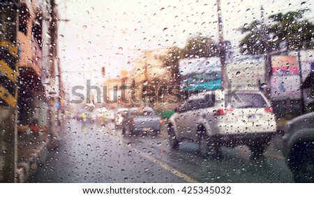 Morning traffic ,view through the wind shield of rainy day.Selective focus and color toned.