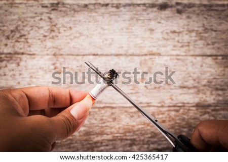 Concept No Smoking,hand women use scissors cutting  cigarette