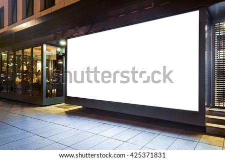 Blank mock up of store street showcase window in a city at night Royalty-Free Stock Photo #425371831