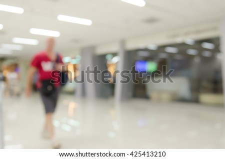 Abstract background,  blurred  image of a man walking in shopping mall or passenger terminal of airport.