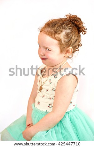 Fashion little girl in green dress, in catwalk model pose, stock photo.