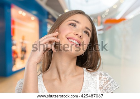 Young elegant woman talking on mobile phone