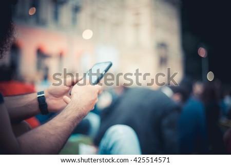 man taking a picture at sunset, listening and attending show music in a park