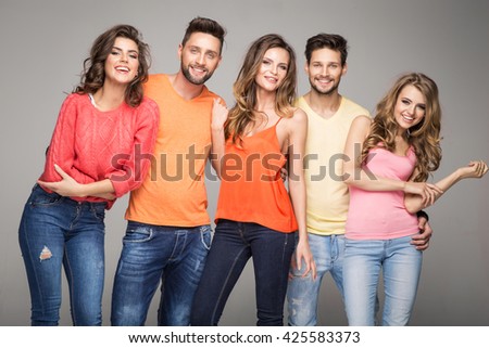 Group of smiling friends wear fashionable colorfull clothes