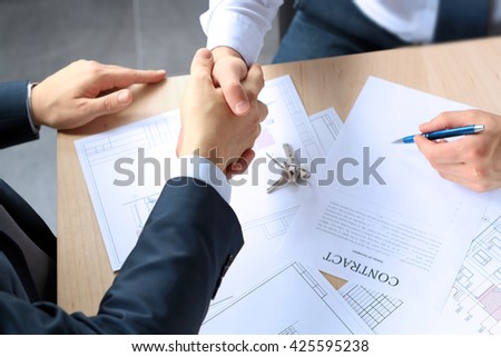Close-up image of a firm handshake between two colleagues after signing a contract Royalty-Free Stock Photo #425595238