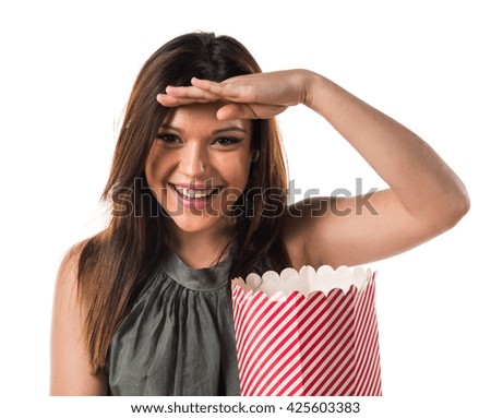 Young brunette girl with popcorns