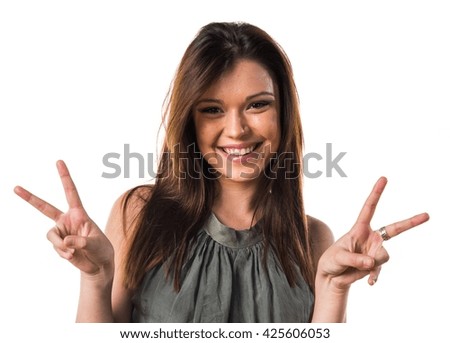 Young girl doing victory gesture