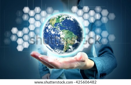 Modern technology in hand.  Elements of this image furnished by NASA