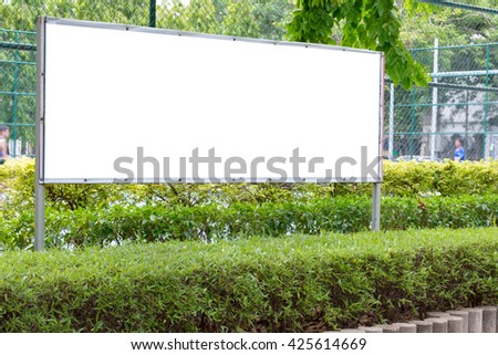 blank billboard in green park.