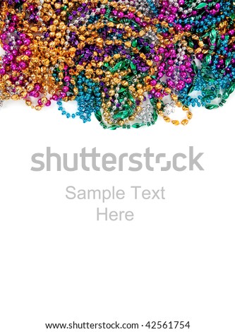 Multi colored mardi gras beads including blue, green, purple, pink, yellow and gold on a white background with copy space