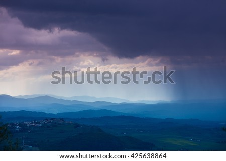 Cloudy rainy sky over mountain valley. Tyscany, Italy