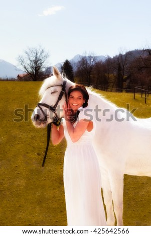 Picture a stunning beautiful woman and her white horse