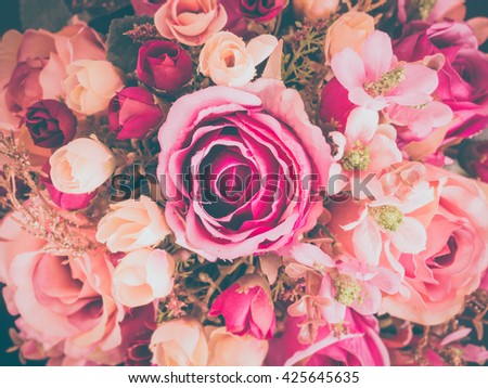 Artificial pink rose bouquet for background (Vintage tone with lens vignetting effect)