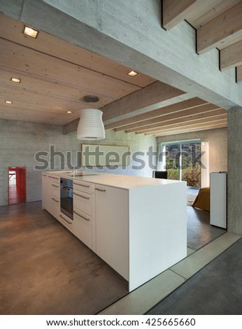 Interior of a modern chalet in cement, white kitchen island