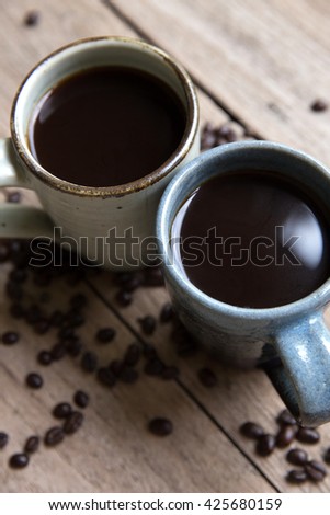 Two (2) coffee cups for lovers prepare for morning coffee with copy blank space for writing on rustic grunge wooden table background.  (top view flat lay)