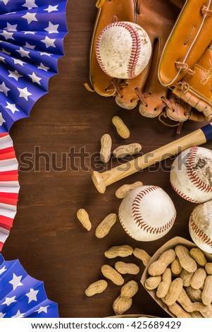 Close up of old worn baseball equipment on a wooden background.