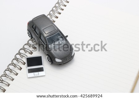 Laptop and car.
Miniature notebook PC and car on notebook.