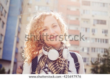 Lovely smiley woman in the street at sunny day