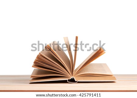 Open book isolated on wooden table. Back to school. Copy space.