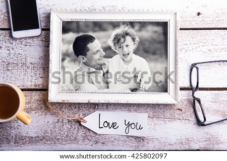 Fathers day composition. Picture of father with son in frame. Young father is enjoying time with his child. Father and son at home. Handsome father with little boy. Happy father and child.