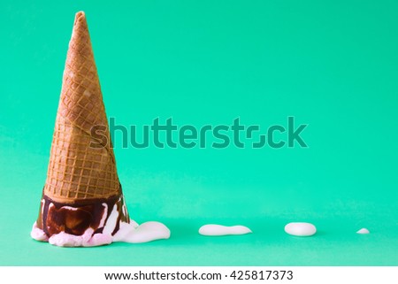 Strawberry ice cream cone on green background
