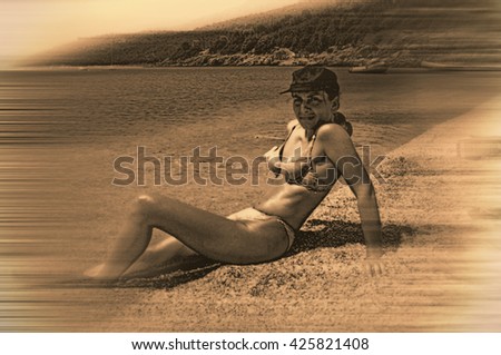 beautiful girl with hat enjoying the sun on the beach. caucasian. tilt shift effect.