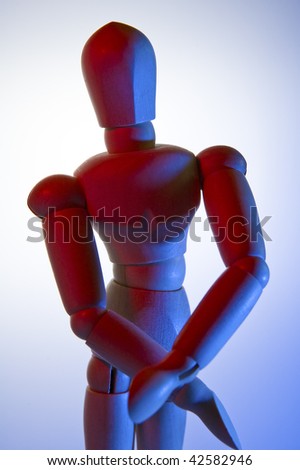 conceptual photo of a wooden figurine, red and blue lights,