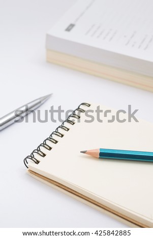 Blank notebook with pencil on white background