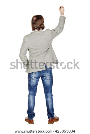 Rear or back view full body picture of male  writing something on glass board with marker