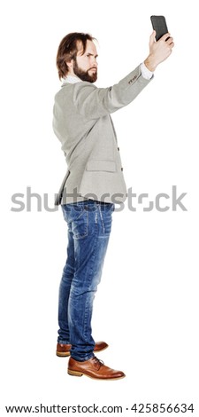 Handsome bearded young business man taking selfie smiling. portrait isolated over white studio background.