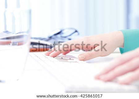 Shot of a businesswoman's hand while typing on keyboard on her computer.