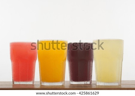 Colorful Fresh Juices over a wooden table