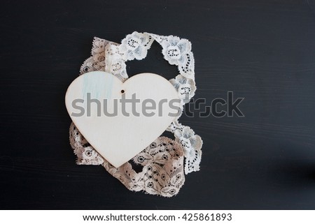 wood  heart on wood table,beige lace, selective focus