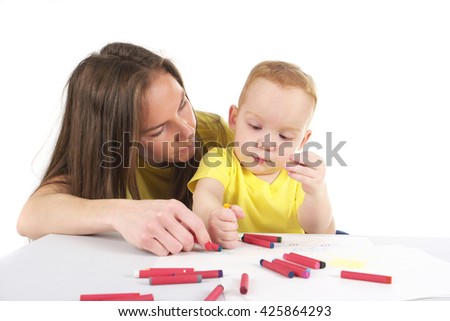 Mother and son are drawing the picture together