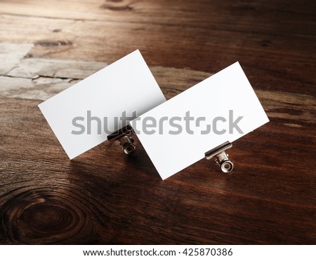 Photo of blank white business cards on wooden table background. Blank ID template. Template for branding identity.