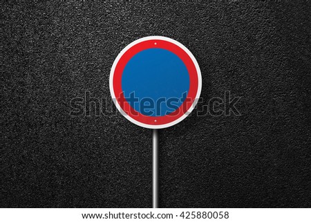 Road sign circular shape on a background of asphalt. The texture of the tarmac, top view.