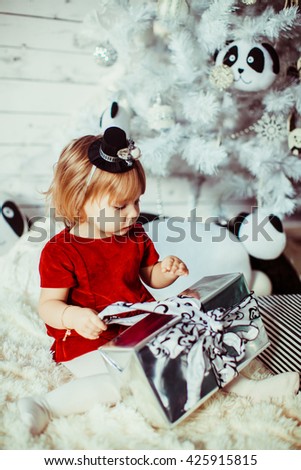 girl with a gift near Christmas tree