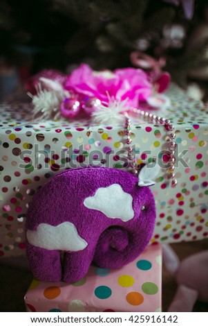 purple elephant near Christmas gifts