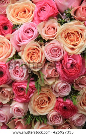 Roses in various bright colors in a mixed bridal bouquet
