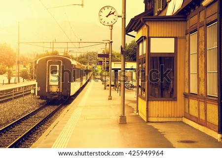 Last train moves away at sunset time. Royalty-Free Stock Photo #425949964
