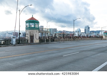concrete road with cityscape and skyline of portland in cloud sky