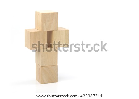 Wooden cross made of blocks is isolated on white background.
