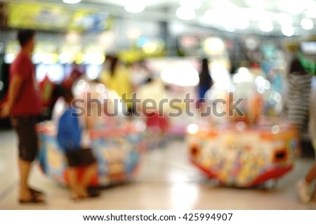 blurred image people of play zone in the mall