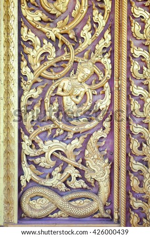 Traditional thai style on temple door in Thailand.