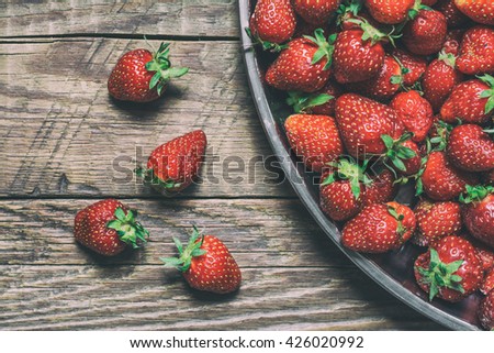 Strawberry on old wooden table in bowl