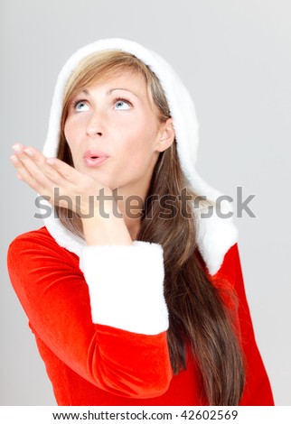 Santa woman blowing sideway to december