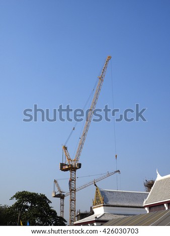 high-rise building crane on top of building , construction site